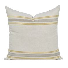 a white pillow with yellow and grey stripes