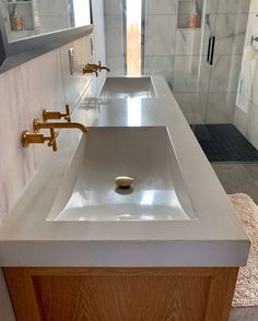 a bathroom with two sinks and mirrors in it