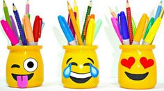 three yellow mugs with pens and pencils in them, one has an emoticive face