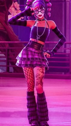 a woman with purple hair and glasses is standing in a dance pose on the stage