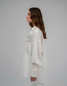 Oversize shirt made of summer natural fabric with hand embroidery. Shirt collar, button fastener. Long sleeve on the cuff.The length of the back is 76 cm / 29, 1 in. Sleeve length with cuff 63 cm / 24, 8 inCare: Machine wash 40°C. Spin: 600-800 rpm Do not tumble dry. Do not use chlorine bleaches or stain removers. Ironing: medium temperature, seamy side.Composition: 50% Tencel, 33% Cotton, 15% Linen, 2% ElastanAbout the brand:7/11 Seven Eleven has been working since July 2015. The brand creates White Shirt With Cuffed Sleeves For Summer, Summer White Shirt With Cuffed Sleeves, White Shirt With Cuffed Sleeves For Spring, Spring White Shirt With Cuffed Sleeves, White Blouse With Cuffed Sleeves For Daywear, Summer Workwear Blouse With Embroidered Cuffs, Long Sleeve Shirt With Embroidered Cuffs For Summer, Spring Embroidered Blouse With Spread Collar, Elegant Embroidered Relaxed Fit Blouse