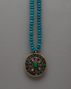 Long Turquoise Beaded Necklace About our locket The beauty of organic turquoise beads and the grace of a copper locket are combined in the Long Turquoise Beaded Necklace. The locket, which was carefully handmade with every detail in mind, has an electrogold coating that gives it a sophisticated appearance. The exquisite visual impression that is produced by the painstaking selection and stringing of each bead is enhanced by the tranquil beauty of the jade stones set inside the locket. In additio Bohemian Turquoise Cabochon Necklace With Round Pendant, Turquoise Medallion Locket Jewelry, Bohemian Turquoise Cabochon Necklace, Turquoise Pendant Beaded Necklace For Meditation, Turquoise Amulet Beaded Necklaces With Natural Stones, Turquoise Round Pendant Amulet Necklace, Turquoise Round Pendant Locket Jewelry, Turquoise Cabochon Necklaces In Spiritual Style, Turquoise Amulet Necklace With Round Pendant