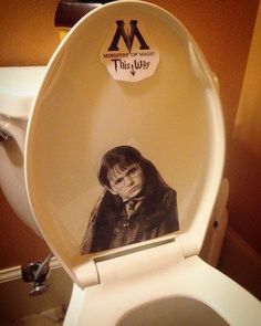 a toilet with the lid up and an image of a woman on it