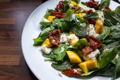 a white plate topped with spinach and cheese