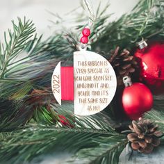 a christmas ornament hanging from a pine tree with ornaments around it and the saying, this ribbon is very special as we can see