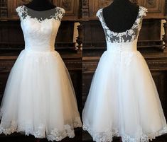 two dresses on mannequins, one in white and the other in black