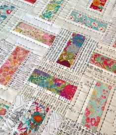 a close up of a patchwork quilt with many different colors and designs on it