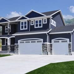 a large house with two garages and three windows