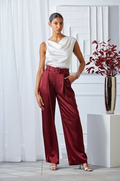 Slip into our Satin Pleated Pants. With front pleats and a removable satin belt, the unique patina and meticulous fit make these pants a standout. Pair them with our Satin Draped neck top or Matte Jersey Knit for a monotone column of refined style. Limited Edition 50th Anniversary Collection Elie Tahari Exclusive Satin Wide Leg Pleated Pant with Self Belt 80% Acetate, 20% Polyester Runs true to Size Measurements: 13.5"L Front Rise, 33"L Inseam (approx. length for a size 6) Model is 5'9" and wear Satin Pants Outfit, Cowl Top, Tahari Dress, Satin Pants, Elie Tahari, Sequin Tank Tops, Jumpsuit Jacket, Long Sleeve Short Dress, Silk Pants