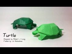 two green origami turtles sitting next to each other