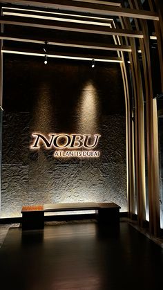 the entrance to nobu atlantic's restaurant is lit up with lights and wood