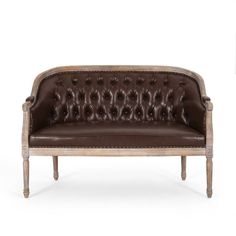 a brown leather couch sitting on top of a wooden frame