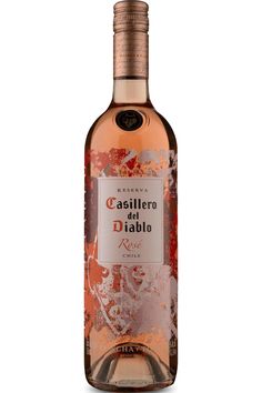 a bottle of wine that is sitting on a white surface with an orange and red design