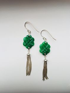 A pair of beautiful Chinese knot green jade earrings designed with 925 sterling silver tassels. The emerald like green jade knots are high quality and all natural, the carvings are vivid and detailed. At the beginning, Chinese knot was used in ceremonies starting Han dynasty. It gets popular in Qing Dynasty and becomes part of folk arts and decorations and gifts. Having no beginning or end, the endlessness knot is known as a wish for long-lasting family union and is believed to bring the receive Elegant Green Dangle Tassel Earrings, Green Tassel Drop Earrings As Gift, Elegant Handmade Green Tassel Earrings, Elegant Nickel-free Tassel Earrings As Gift, Elegant Nickel-free Tassel Earrings For Gift, Elegant Green Handmade Tassel Earrings, Traditional Green Jade Earrings, Traditional Green Dangle Tassel Earrings, Silver Tassel Earrings