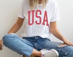 Show your patriotic spirit in style with our USA graphic t-shirt. Whether you're at the parade or hanging out with friends, you can rock your American pride with this fashionable tee. We're gonna make you an offer you can't refuse: the best 100% cotton tee you've ever tried. Pre-shrunk fabric? Check. Side-seamed construction? Check. Best fit ever? Double check. * 100% combed and ring-spun cotton (Heather colors contain polyester) * Fabric weight: 4.2 oz/yd² (142 g/m²) * Pre-shrunk fabric * Side- 4th Of July Streetwear T-shirt With Letter Print, 4th Of July Relaxed Fit Screen Print T-shirt, Relaxed Fit Screen Print T-shirt For 4th Of July, Patriotic Screen Print Tops For Memorial Day, 4th Of July Relaxed Fit T-shirt With Text Print, American Style Red T-shirt With Letter Print, Patriotic 4th Of July Streetwear T-shirt, Memorial Day Streetwear T-shirt With Letter Print, Patriotic Relaxed Fit T-shirt With Letter Print