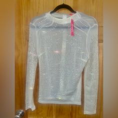 Sheer Beaded Long Sleeved Top Stretch Beaded Top For Party, Glamorous Embellished Top For Winter, Beaded Tops For Night Out In Spring, White Long Sleeve Top For Party Season, Chic Fitted Blouse With Rhinestones, Spring Stretch Tops With Rhinestones, Fitted Beaded Tops For Spring, Beaded Tops For Night Out In Fall, Rhinestone Blouse For Spring