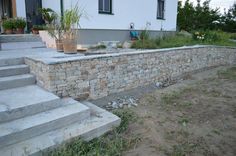 a stone wall with steps leading up to it