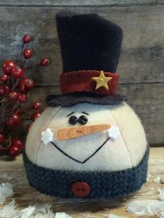 a stuffed snowman with a top hat on