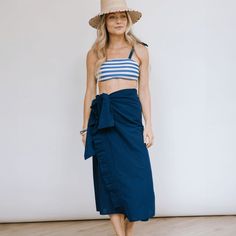 The sarong is the best accessory for your days at the pool or beach. And takes up zero room in your suitcase when you're packing for your beach vacation! Breezy, comfortable, and versatile our Navy Sandy Sarong can be worn tied around the waist or even tied around the neck as a dress. This sarong is the perfect neutral with stunning ruffle detailing so it's easy to accessorize! Monogram Timeline: Please note the monogram process takes up to one week prior to shipment. Details and Care Measures 4 Grey Hall, Denim Jumpsuit, Womens Activewear, Sarong, Color Shades, A Dress, Swimwear Tops, The Pool, Sweater Skirt