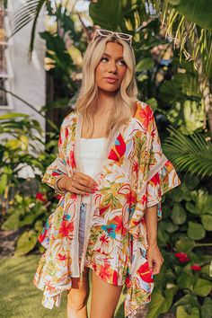 - Hit the beach with truly tropical style with this vibrant piece! - Unlined material with a colorful floral print and crochet accents - Short, draped sleeves with ruffle detail - An open draped front with tie closure - A relaxed silhouette that ends in a ruffled hemline Drape Sleeves, Tropical Style, Floral Prints, Crochet, Floral, Color