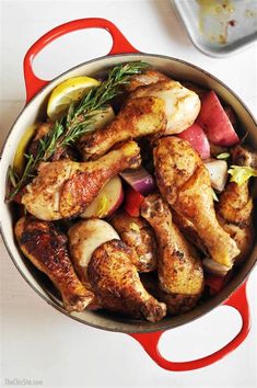 a pot filled with chicken and vegetables on top of a table