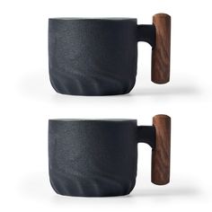 two coffee mugs with wooden handles are shown in black and grey colors, one is made out of wood