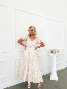 Introducing our custom, one-of-a-kind Timeless Grace Floral Puff Sleeve Midi Dress! This exclusive dress features a beautiful hand-designed Flourish in Frills, making it truly unique and unavailable anywhere else. The bump-friendly design, sweet floral print, sweetheart neckline, and lace detail add a touch of girly charm. Comfy and chic - the perfect dress for any occasion. Tiered skirt Puff sleeves Elastic stretch at bust and sleeves Rouching at bust Lace trim detail Sweetheart neckline 100% C Bohemian Puff Sleeve Dresses For Party, Bohemian Puff Sleeve Party Dress, Feminine Long Cream Dress, Flowy Puff Sleeve Sundress, Flowy Cream Midi Dress For Garden Party, Cream Midi Length Dress For Garden Party, Tiered Dress With Fitted Bodice For Garden Party, Garden Party Dress With Fitted Bodice And Tiered Shape, Garden Party Tiered Dress With Fitted Bodice