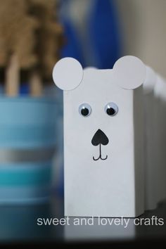 a white paper bag with a bear face on it's side and the words sweet and lovely crafts above it