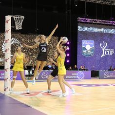 the girls are playing basketball on the court in front of an audience at a sporting event