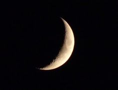 the crescent moon is seen in the dark night sky, with only one half visible