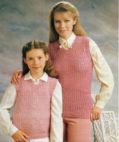 two girls wearing pink sweaters and white shirts