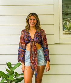 Discover the epitome of bohemian style with our Boho Wrap Top. Perfect for festivals, vacations, or casual lounging, this versatile piece will become a staple in your wardrobe. Our Boho Wrap Top is designed for the modern bohemian soul. With its striking boho print and flattering bell sleeves, this top is perfect for making a statement. The wrap top fit allows it to accommodate comfortably from 28" to 50" at both the bust and bottom, ensuring a snug yet flexible fit for a variety of body shapes and sizes. Whether you're heading to a music festival, dancing the night away, or enjoying a relaxed vacation, this crop top is your go-to piece. Its versatile design lets you wear it off the shoulder for a more laid-back look or on the shoulder for a touch of elegance. Crafted from premium rayon, t Cheap Patterned Festival Blouse, Bohemian Multicolor Tops With Paisley Print, Bohemian Multicolor Peasant Top With Floral Print, Summer Boho Print Tops, Bohemian Printed Summer Tops, Bohemian Printed Tops For Summer, Casual Printed Peasant Top For Festivals, Multicolor Bohemian Blouse With Floral Print, Summer Vacation Tops With Boho Print