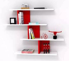 three white shelves with books and other items on them