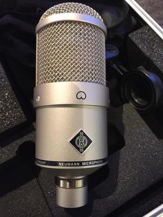 a silver microphone sitting on top of a table