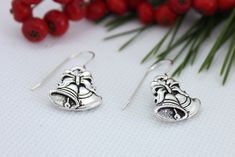 Hilaryannedesigns Christmas Bell Earrings are perfect for the lady who enjoys wearing Christmas Jewelry that is good quality and elegant.  I know that we enjoy looking our best, so it only is fitting that the jewelry that you wear is also high quality.  The Earring Wire is Sterling Silver.  The Christmas Bell Charm is made from high quality lead-free Pewter and is Silver-plated.  With the added Swarovski Crystal they are very beautiful and FUN!   I give the FUN option of buying a set with one Green and one Red Crystal *The Christmas Bell Charm is Silver-Plated Pewter (made in California, USA) (Lead-free) *The Red and Green accent beads are Swarovski Crystals  *The Sterling Silver delicate ear wires are 1.8 cm (without the charms and            beads) *The Length of the earring plus Christm Bell Earrings, Christmas Tree Charm, Holiday Necklace, Earring Wire, Christmas Necklace, Jewelry Elegant, Christmas Bell, Gold Cross Necklace, Silver Christmas