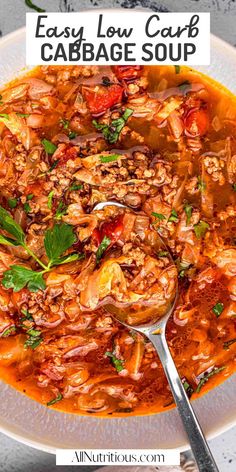 an easy low carb cabbage soup in a white bowl with a spoon on the side