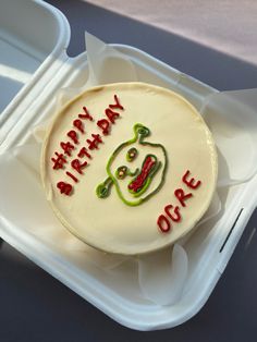 a birthday cake in a plastic container with writing on the frosting and icing