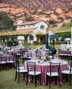 an outdoor wedding reception with purple linens