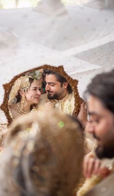 the bride and groom are looking at each other in front of a mirror with their reflection