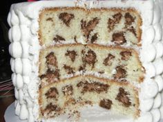 a cake with white frosting and chocolate toppings on it's sides is cut into squares