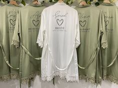 three bride shirts hanging up on a rack