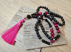 I made this beautiful long necklace using Natural Magenta Tiger's Eye (10 mm, 0.39 inch), Light Pink Shell (6mm, 0.23 inch), Black Lava (8mm, 0.31 inch) Black Onyx (12mm, 0.47 inch-8mm, 0.31 inch- 6mm, 0.23 inch) Beads and Metal Boho Spacer Beads. The length of this beautiful long necklace including Silky Tassel is 480 mm (18.9 inch.).  Made in a smoke free and pet free home. 🎁Nice wrapping paper, and ribbon with a card including your message is available with few extra dollars. Please select a Gemstone Beads Long Necklace Gift, Long Gemstone Beads Necklace As Gift, Long Necklace With Round Gemstone Beads For Gift, Gift Long Necklace With Round Gemstone Beads, Lariat Necklace With Round Beads As Gift, Round Beads Single Strand Lariat Necklace As Gift, Hand-strung Lariat Beads As A Gift, Hand-strung Lariat Beads For Gift, Spiritual Lariat Necklace With Round Beads