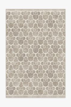 a beige rug with circles on it and a white border in the middle, against a light gray background