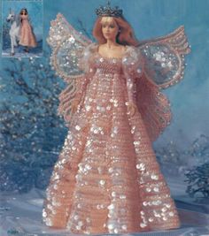 an angel doll is wearing a pink dress with sequins