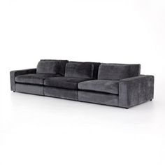 a gray couch sitting on top of a white floor