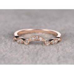 a rose gold wedding band with white diamonds