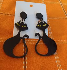 Vintage style black cat earrings.Just in time for spooky season. Earring dangle 2" long. Made of acrylic. Studs with 2 backings. Black Cat Ears Earrings For Halloween, Trendy Black Halloween Earrings, Black Cat Ears Earrings For Party, Black Cat Design Earrings For Halloween, Black Cat Design Drop Earrings, Black Cat Earrings, Cat Earrings, Halloween Jewelry, Black Cat