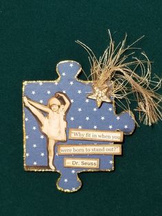 a wooden ornament with an image of a ballerina on it's side