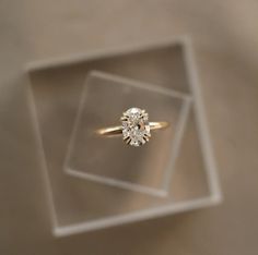 an engagement ring in a clear box