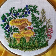 a cross stitched picture of two mushrooms in the grass